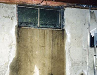 Water pouring out from a basement window in Rifle 